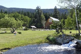 Exterior shot of Country Wedding Venue with streams, barn, and nice grass.