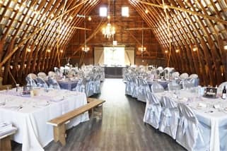 Elegant Country Style Wedding Venue with tables and a high vaulted barn ceiling